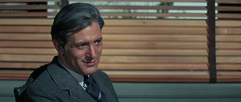 Movie still from “The Learning Tree” (1969), directed by Gordon Parks – A person wearing a suit and tie; Close Up shot, Over the shoulder angle