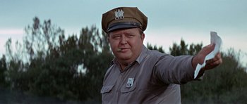 Movie still from “The Learning Tree” (1969), directed by Gordon Parks – A man in a brown hat is smoking a cigarette; Close Up shot, Low angle
