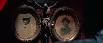 Movie still from “The Learning Tree” (1969), directed by Gordon Parks – A crucifixion statue and two framed pictures; Extreme Close Up shot, Low angle