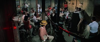 Movie still from “The Learning Tree” (1969), directed by Gordon Parks – A group of people sitting around a table; Wide shot, High angle