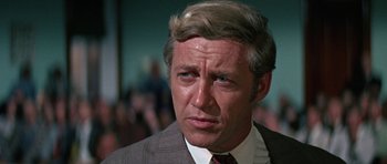 Movie still from “The Learning Tree” (1969), directed by Gordon Parks – A person wearing a suit and tie; Close Up shot, Low angle