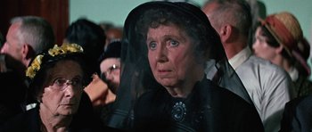 Movie still from “The Learning Tree” (1969), directed by Gordon Parks – An older woman wearing a black hat and a black veil; Close Up shot, Over the shoulder angle