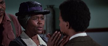 Movie still from “The Learning Tree” (1969), directed by Gordon Parks – An older woman and a young man are talking to each other; Close Up shot, Over the shoulder angle