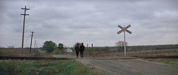 Movie still from “The Learning Tree” (1969), directed by Gordon Parks – Two people are standing on the railroad tracks; Extreme Wide shot, High angle