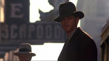 Movie still from “The Legend of Bagger Vance” (2000), directed by Robert Redford – A man wearing a hat and a suit; Close Up shot, Low angle