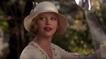 Movie still from “The Legend of Bagger Vance” (2000), directed by Robert Redford – A woman wearing a white hat with a flower in her hair; Close Up shot, Over the shoulder angle