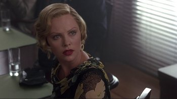 Movie still from “The Legend of Bagger Vance” (2000), directed by Robert Redford – Charlize theron in a black and yellow dress; Close Up shot, Over the shoulder angle