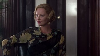 Movie still from “The Legend of Bagger Vance” (2000), directed by Robert Redford – A woman with blonde hair wearing a black and yellow dress; Close Up shot, Low angle