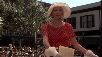 Movie still from “The Legend of Bagger Vance” (2000), directed by Robert Redford – A woman in a red polka dot dress and a white hat; Medium shot, Low angle