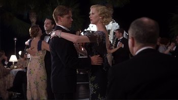 Movie still from “The Legend of Bagger Vance” (2000), directed by Robert Redford – A man and a woman dancing together at an event; Medium shot, Low angle