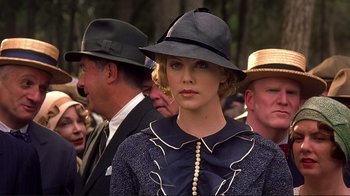 Movie still from “The Legend of Bagger Vance” (2000), directed by Robert Redford – A woman wearing a hat and a dress; Close Up shot, Low angle