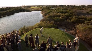 Movie still from “The Legend of Bagger Vance” (2000), directed by Robert Redford – A group of people standing on top of a grass covered field; Extreme Wide shot, High angle