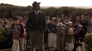 Movie still from “The Legend of Bagger Vance” (2000), directed by Robert Redford – A man standing in front of a group of people; Medium shot, Low angle