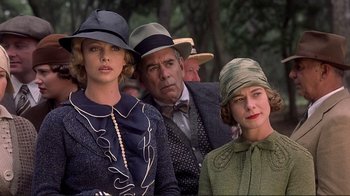 Movie still from “The Legend of Bagger Vance” (2000), directed by Robert Redford – A group of people wearing hats and suits; Close Up shot, Low angle