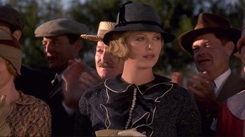 Movie still from “The Legend of Bagger Vance” (2000), directed by Robert Redford – A woman wearing a hat is standing next to a man; Close Up shot, Low angle