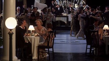 Movie still from “The Legend of Bagger Vance” (2000), directed by Robert Redford – A group of people sitting around a table at an event; Wide shot, High angle