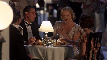 Movie still from “The Legend of Bagger Vance” (2000), directed by Robert Redford – A man and a woman sitting at a dinner table; Medium shot, Over the shoulder angle