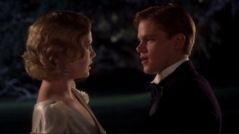 Movie still from “The Legend of Bagger Vance” (2000), directed by Robert Redford – A man and a woman standing next to each other in front of trees; Close Up shot, Low angle