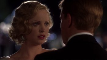 Movie still from “The Legend of Bagger Vance” (2000), directed by Robert Redford – A man and a woman in formal wear looking at one another; Close Up shot, Over the shoulder angle