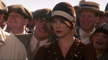 Movie still from “The Legend of Bagger Vance” (2000), directed by Robert Redford – A man and a woman wearing hats in a crowd of people; Close Up shot, Over the shoulder angle