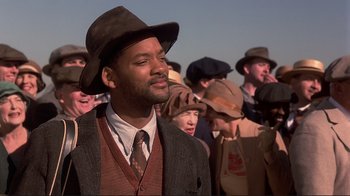 Movie still from “The Legend of Bagger Vance” (2000), directed by Robert Redford – A crowd of people wearing hats and suits and ties; Close Up shot, Low angle