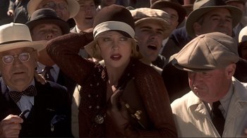 Movie still from “The Legend of Bagger Vance” (2000), directed by Robert Redford – A crowd of people wearing hats and a brown jacket; Close Up shot, Low angle
