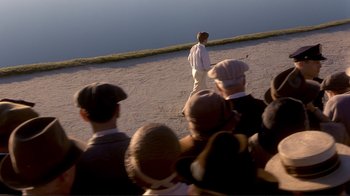 Movie still from “The Legend of Bagger Vance” (2000), directed by Robert Redford – A group of people standing in front of a body of water; Extreme Wide shot, High angle