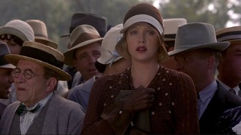Movie still from “The Legend of Bagger Vance” (2000), directed by Robert Redford – A group of people standing in a crowd wearing hats and gloves; Close Up shot, Over the shoulder angle