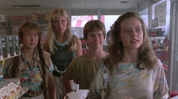 Movie still from “The Legend of Billie Jean” (1985), directed by Matthew Robbins – A group of young people standing in a room together; Medium shot, Low angle