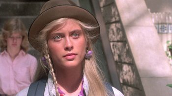 Movie still from “The Legend of Billie Jean” (1985), directed by Matthew Robbins – A woman with long blonde hair wearing a hat; Close Up shot, Low angle