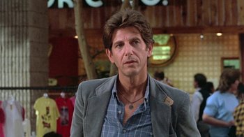 Movie still from “The Legend of Billie Jean” (1985), directed by Matthew Robbins – A person wearing a jacket; Close Up shot, Over the shoulder angle