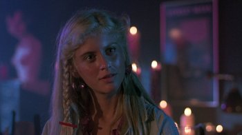 Movie still from “The Legend of Billie Jean” (1985), directed by Matthew Robbins – A woman with long blonde hair wearing a white shirt; Close Up shot, Over the shoulder angle