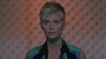 Movie still from “The Legend of Billie Jean” (1985), directed by Matthew Robbins – A person with short blonde hair; Close Up shot, Low angle