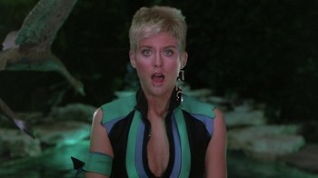 Movie still from “The Legend of Billie Jean” (1985), directed by Matthew Robbins – A person with short blonde hair; Close Up shot, Over the shoulder angle