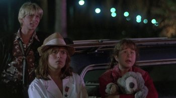 Movie still from “The Legend of Billie Jean” (1985), directed by Matthew Robbins – Two young girls sitting in the back of a car at night; Medium shot, Low angle