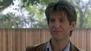 Movie still from “The Legend of Billie Jean” (1985), directed by Matthew Robbins – A person wearing a jacket; Close Up shot, Over the shoulder angle