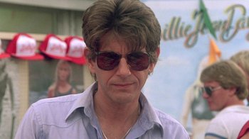 Movie still from “The Legend of Billie Jean” (1985), directed by Matthew Robbins – A person wearing sunglasses; Close Up shot, Low angle