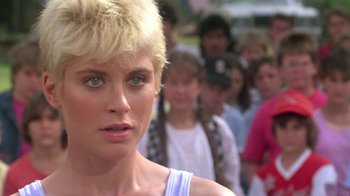 Movie still from “The Legend of Billie Jean” (1985), directed by Matthew Robbins – A woman standing in front of a crowd; Close Up shot, Over the shoulder angle