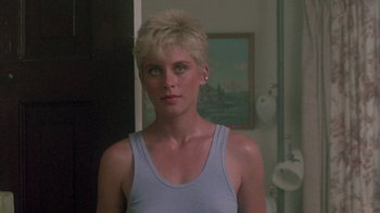 Movie still from “The Legend of Billie Jean” (1985), directed by Matthew Robbins – A person with short blonde hair; Close Up shot, Over the shoulder angle