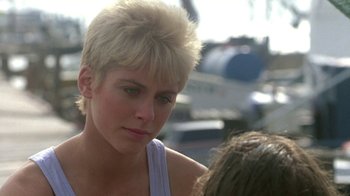 Movie still from “The Legend of Billie Jean” (1985), directed by Matthew Robbins – A person with short blonde hair; Close Up shot, Over the shoulder angle