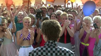 Movie still from “The Legend of Billie Jean” (1985), directed by Matthew Robbins – A group of people standing in front of each other; Medium shot, Over the shoulder angle