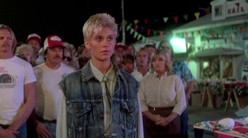 Movie still from “The Legend of Billie Jean” (1985), directed by Matthew Robbins – A group of people standing in front of each other; Medium shot, Over the shoulder angle