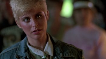Movie still from “The Legend of Billie Jean” (1985), directed by Matthew Robbins – A person wearing a jacket; Close Up shot, Over the shoulder angle