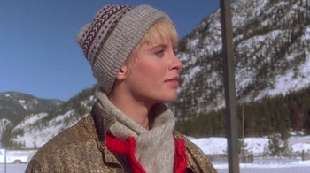 Movie still from “The Legend of Billie Jean” (1985), directed by Matthew Robbins – A woman wearing a hat and a scarf in front of a snowy mountain; Close Up shot, Low angle
