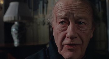 Movie still from “The Legend of Hell House” (1973), directed by John Hough – An old man with a sad look on his face; Close Up shot, Low angle