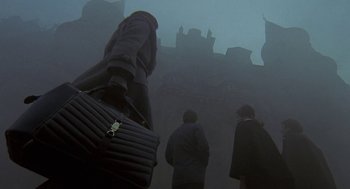 Movie still from “The Legend of Hell House” (1973), directed by John Hough – A group of people walking on a foggy street; Wide shot, Low angle