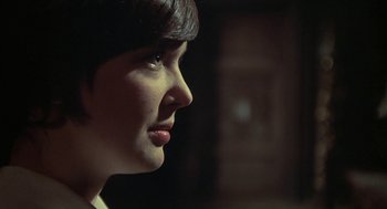 Movie still from “The Legend of Hell House” (1973), directed by John Hough – A woman's face in the dark; Close Up shot, Over the shoulder angle