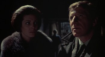 Movie still from “The Legend of Hell House” (1973), directed by John Hough – A man and a woman standing next to each other in the dark; Close Up shot, Low angle