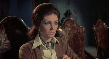 Movie still from “The Legend of Hell House” (1973), directed by John Hough – A person sitting in a chair; Close Up shot, Over the shoulder angle