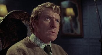 Movie still from “The Legend of Hell House” (1973), directed by John Hough – A person wearing a sweater; Close Up shot, Low angle